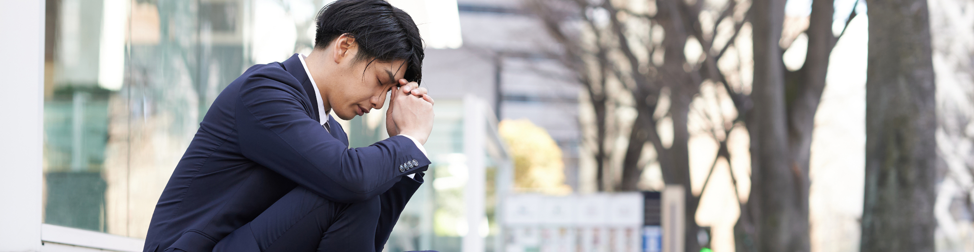 Man crouching holding his head, man with anxiety