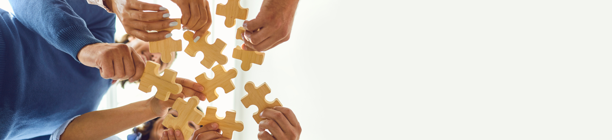 hands putting a puzzle together